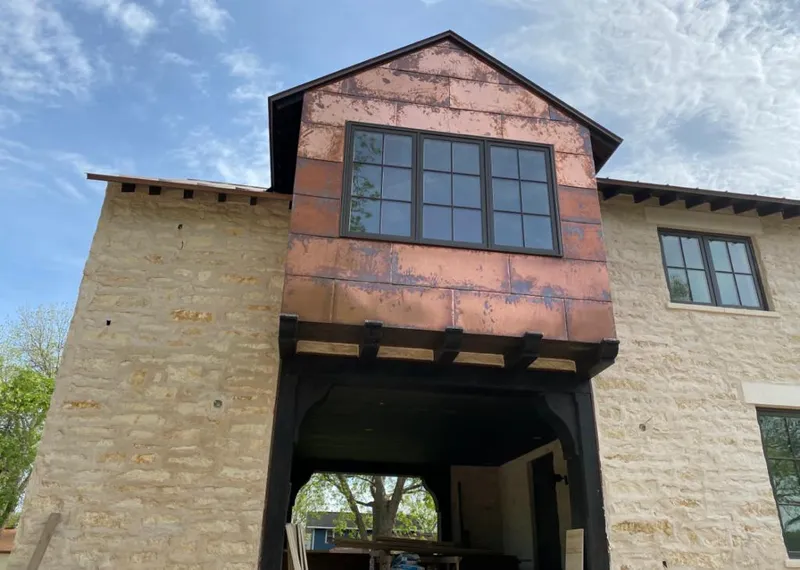 Copper metal panel facade on a stone building for Metal Roof Coating in Brentwood