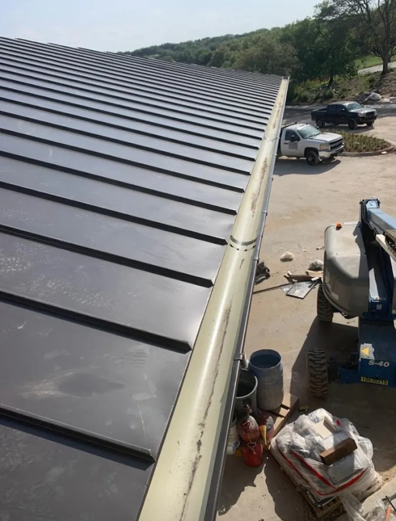Standing seam panel and gutter detail on a metal roofing jobsite in Brentwood